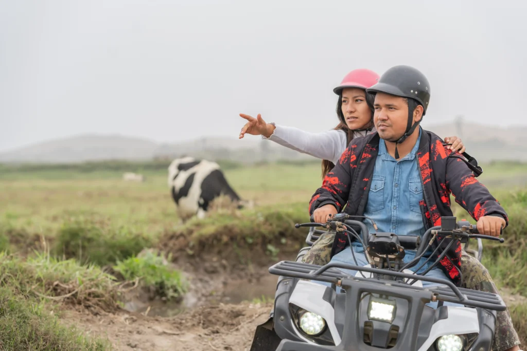 woman points while riding an atv with man 2026 03 19 22 54 48 utc Electric Quad Bike Farming Running Costs